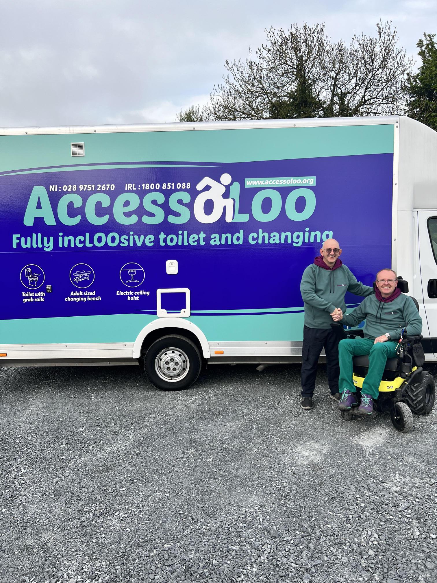 Ceri Davies and Michael Holden MBE pictured shaking hands in front of AccessoLoo Zack