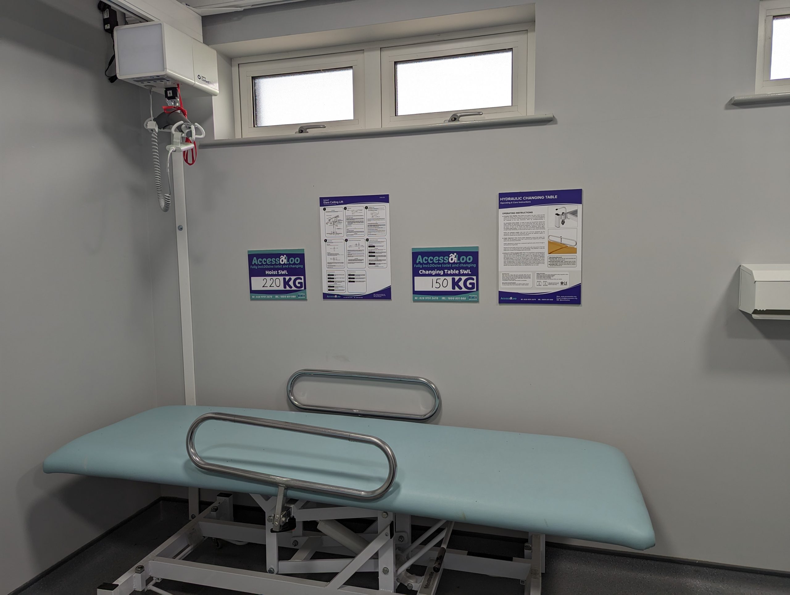 Hoist and changing table close up. With operational signage located on the wall.